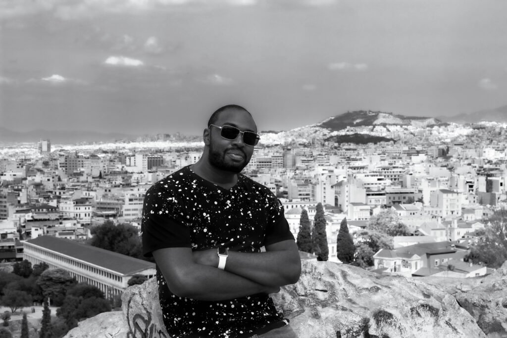 Black man overlooking the city of Athens, Greece from a scenic viewpoint during his travels